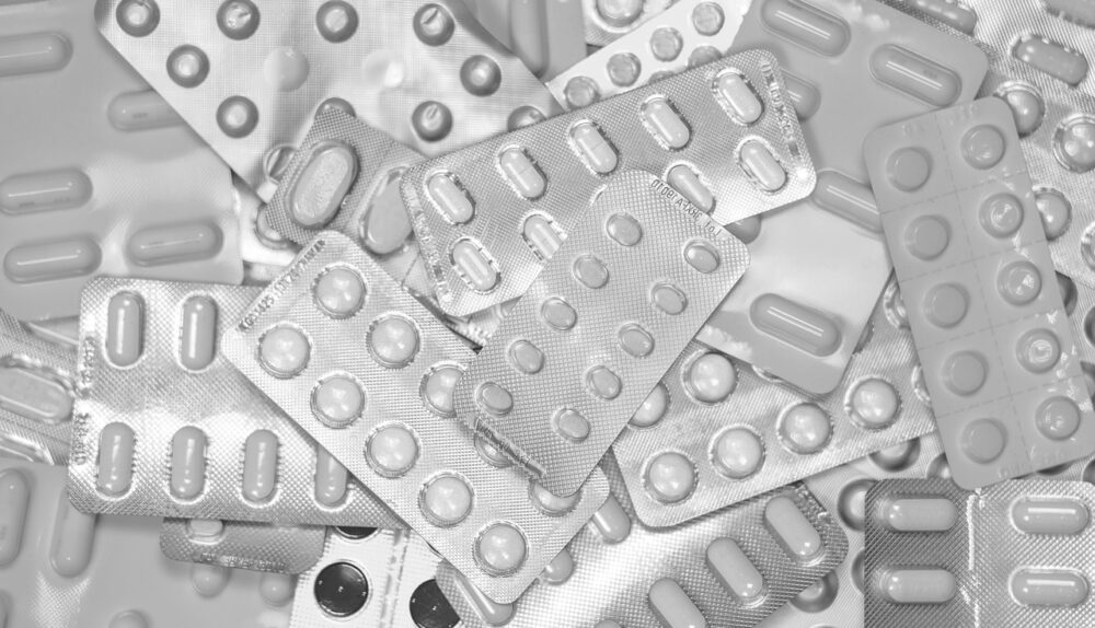 modern pills and tablet on a digital background