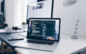engineers coding on laptops