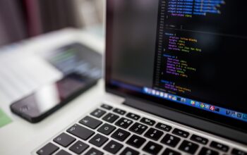 laptop with colorful code graphs