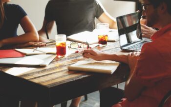 collaborative office team laptops video call ai interface diverse coworkers