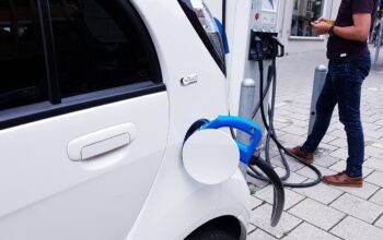 electric car charging station, sleek eco friendly cars