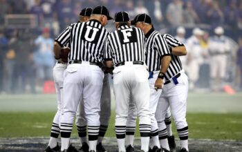 football players huddle together