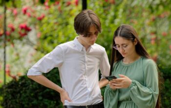young people using smartphones outdoors