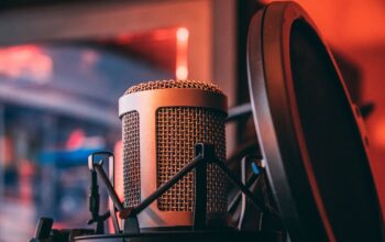 business podcast microphone, headphones, modern office background