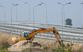 construction site with drones and workers