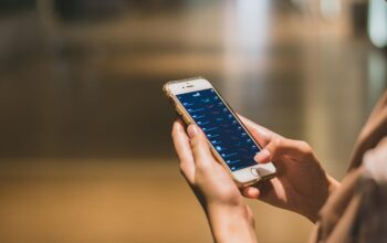 person holding phone with app interface