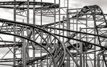 colorful theme park with rollercoasters and managers