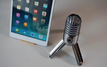 podcasting microphone with financial charts background