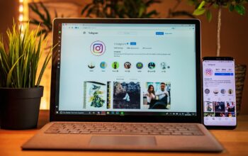 sleek green laptop on desk with recycle icons