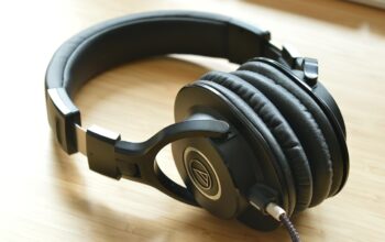 engineers collaborating with headphones and laptops